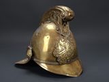 an antique brass helmet with a lion head on the side of it