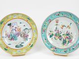 pair of chinese famille plates with figures and flowers on them