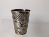 a silver cup that is sitting on a table