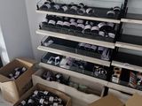 several boxes of wine are stacked on a shelf in a room