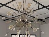 a chandelier made of forks and spoons hanging from the ceiling