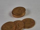 a pile of coins sitting on top of a white table