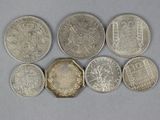 six different british coins sitting on top of each other on a table