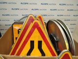 a cardboard box filled with a lot of road signs