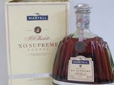 a bottle of brandy in front of a box
