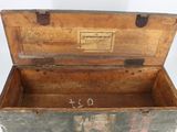 an old wooden box with writing on it
