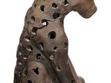 a statue of a dog with holes in it ' s body