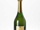 a close up of a bottle of champagne on a white surface