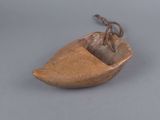 an old wooden boat with a metal hook attached to it ' s side