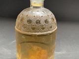 an image of a glass bottle with a yellow liquid inside of it