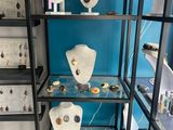 display case with a variety of jewelry on it in a store