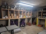 a room with a lot of shelves and tables in it
