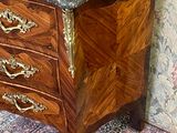 a marble top chest of drawers in a room