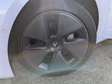 a close up of a tire on a white car