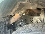 a close up view of a car ' s engine and exhaust pipe