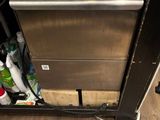 an image of a dishwasher under a counter in a kitchen