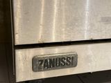 a stainless steel oven sitting on a tiled floor
