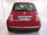 a red car that is parked in a white room