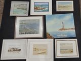 a lot of paintings on a table with a black table cloth