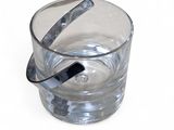 a glass of water with a spoon sticking out of it