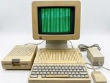an old computer with a green screen and keyboard