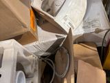 a pile of boxes and a toilet in the middle of the street
