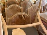 a chair that is sitting in front of a wallpapered wall