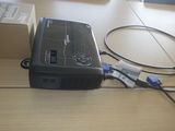 a small projector sitting on top of a wooden table