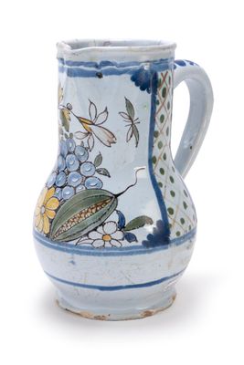 a blue and white vase with a bird and flowers on it