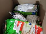 a box full of cat food and a bag of cat food
