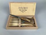 a wooden box with a set of knives in it