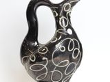 a black and white vase with swirl designs on it