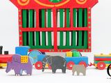 brightly colored wooden toy train set with elephant, elephant and train car