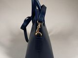 a close up of a blue handbag on a white surface