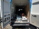 a white van with its door open and a bunch of items in the back