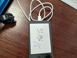 a cell phone with a note attached to it sitting on a desk