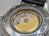 a close up of a watch on a white surface