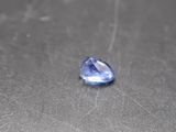 a close up of a blue sapphire stone on a table