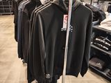 a lot of clothes hanging on a rack in a store