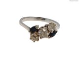 une image d'une bague en diamant et saphir sur fond blanc