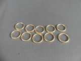 a close up of a bunch of gold rings on a table