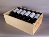 bottles of red wine in a wooden box on a table