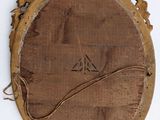 a picture of a wooden mirror hanging on the wall