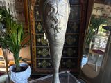 a silver vase sitting on top of a table in front of a mirror