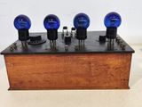 a wooden box with three blue light bulbs on it