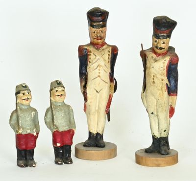 several toy soldiers are standing next to each other on a white surface