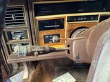 an old car dashboard with a lot of junk on it