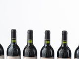several bottles of wine are lined up on a table