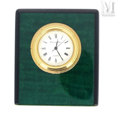 a clock that is sitting on a green surface
