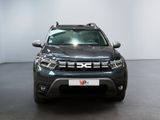 the front view of a grey dacia parked in a showroom